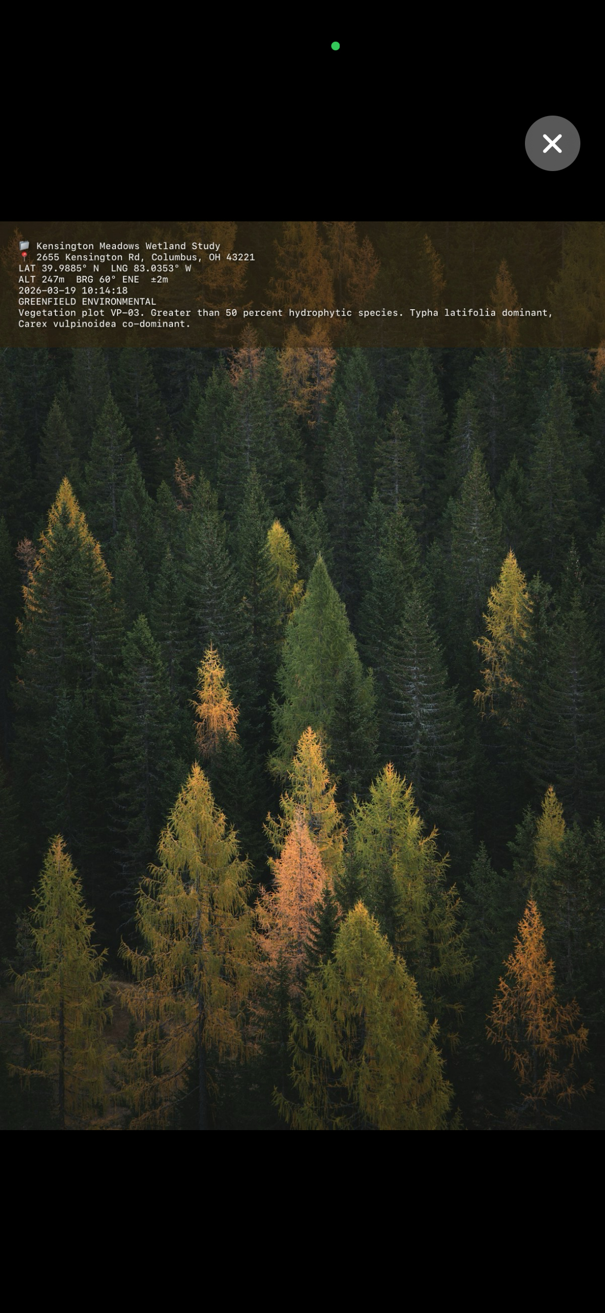 Full stamped photo showing GPS coordinates, address, project name, and voice note text overlaid on a landscape photo